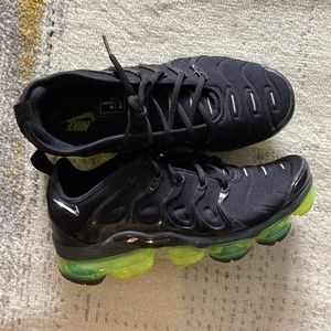 Green and black nike shoes